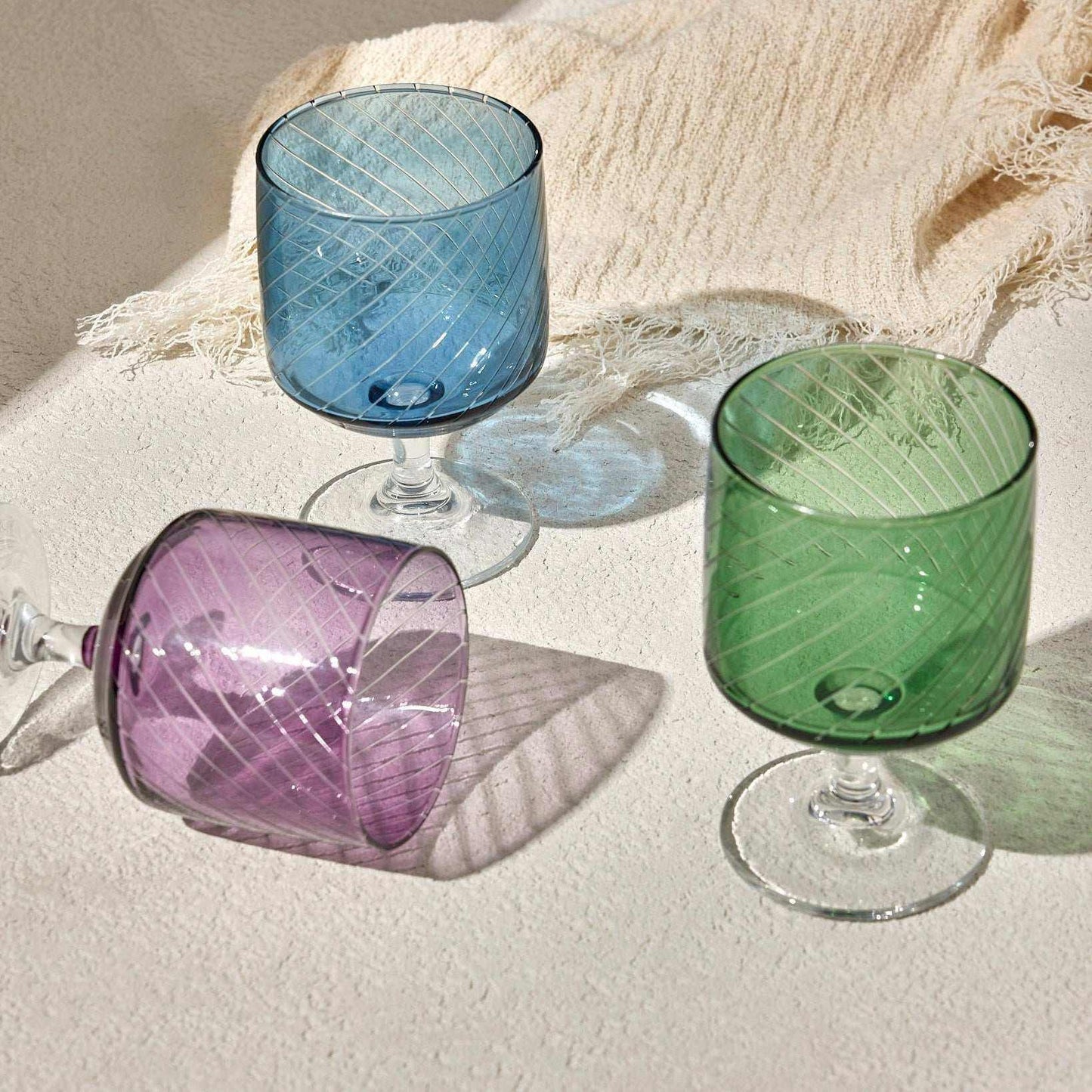 LAL WINE GLASS - PURPLE Elevate your table setting with this elegant purple wine glass, featuring a modern diagonal stripe design and a sleek, clear stem. Perfect for serving wine, cocktailGlass