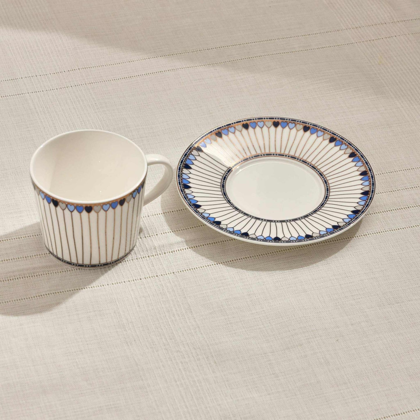 HEARTS PORCELAIN TEA CUP - BLUEAdd a touch of elegance to your tea time with this beautifully crafted porcelain tea cup and saucer set. Featuring a captivating red and white design with delicate hCUP AND SAUCER
