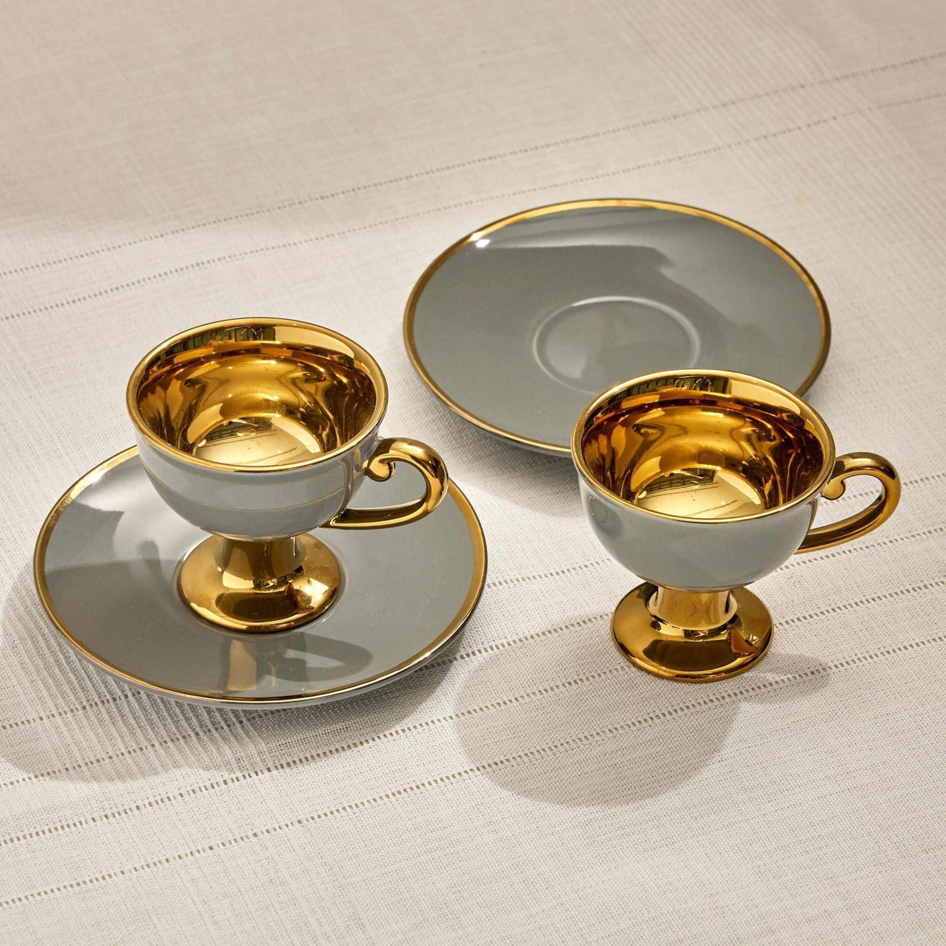 LALIA CUP GRAY - SET OF 2Add a touch of luxury to your drinkware collection with the Lalia Cup Gray Set of 2, featuring a sleek matte gray exterior and a stunning gold interior. Perfect for CUP AND SAUCER