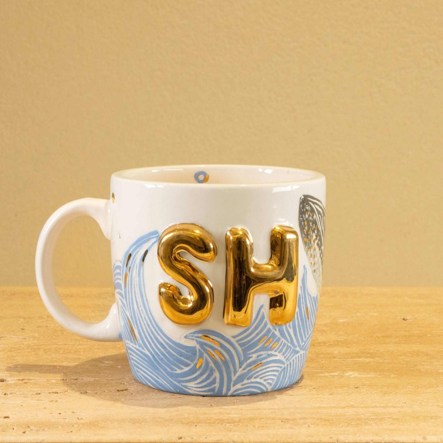 Personalized handmade ceramic mug with gold-plated letters "SH" and floral design.