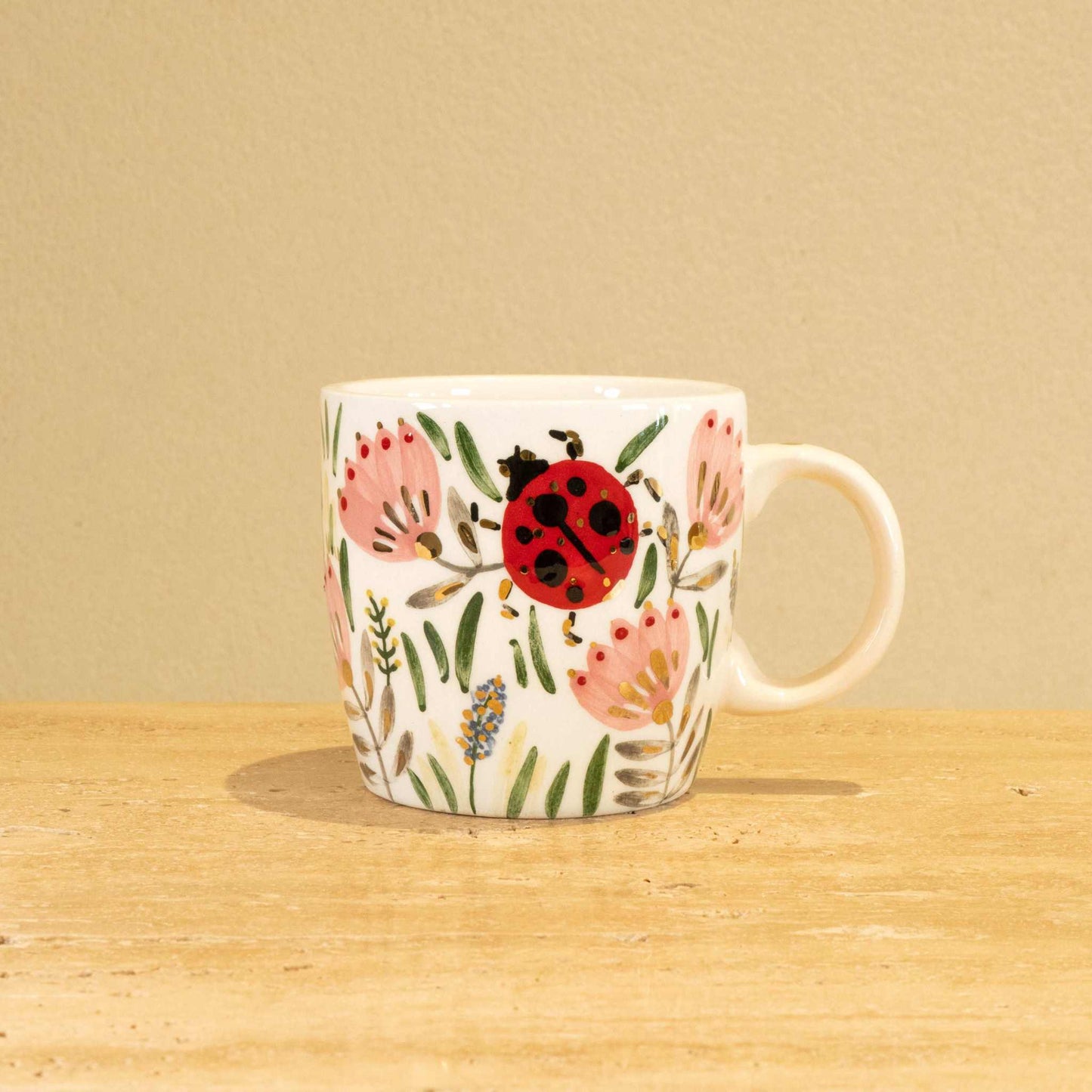 Personalized handmade ceramic mug with gold-plated letter "Y" and floral design.