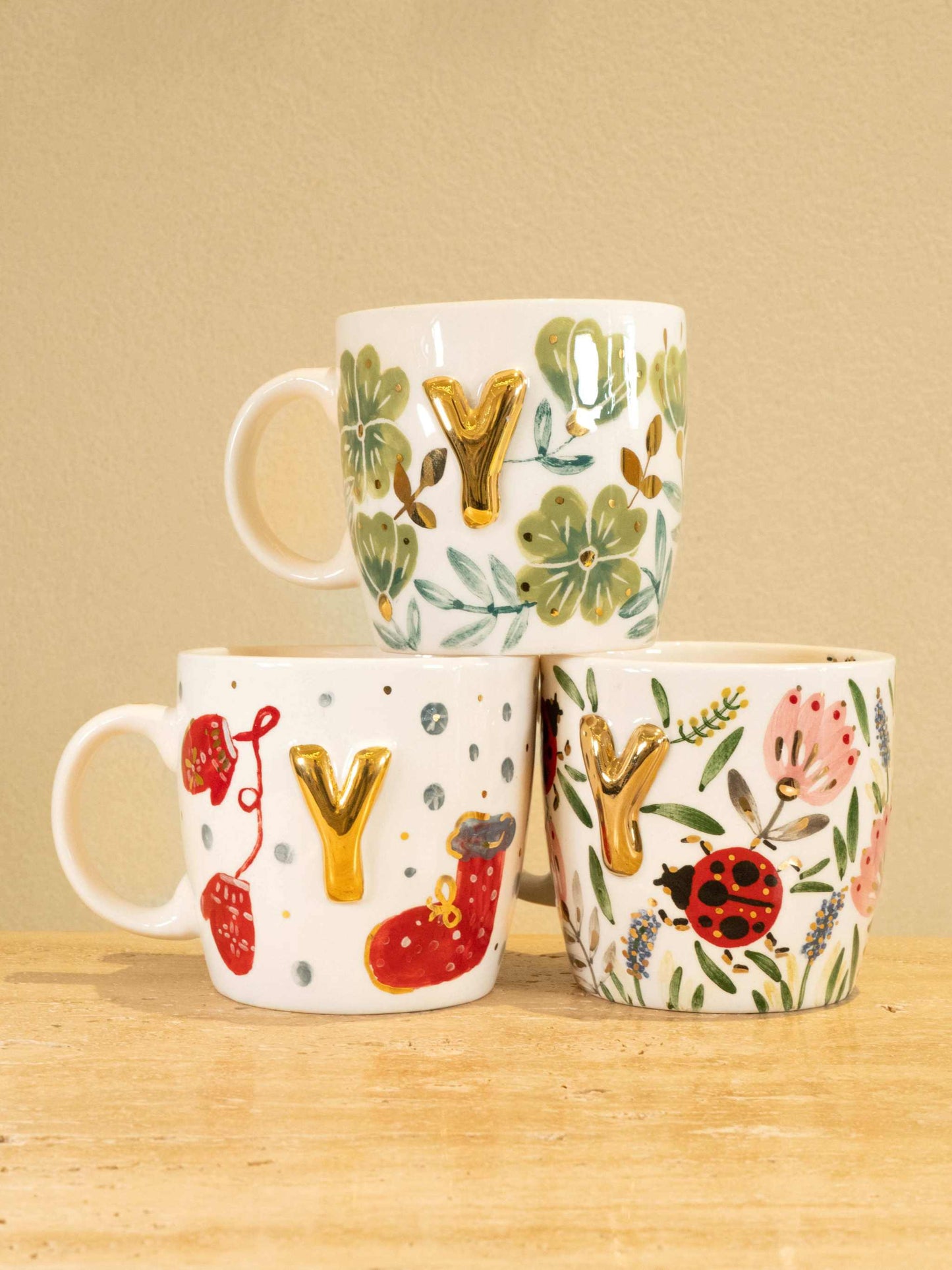 Personalized handmade ceramic mug with gold-plated letter "Y" and floral design.