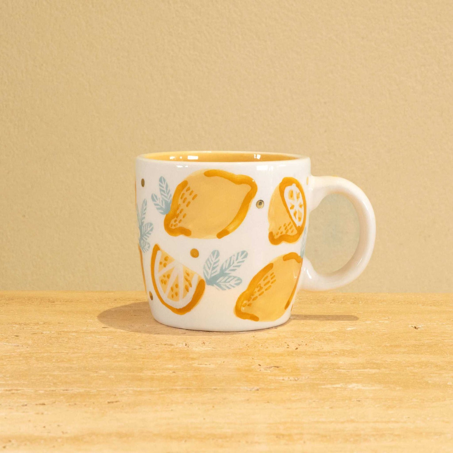 Personalized handmade ceramic mug with gold-plated letter M and floral design.