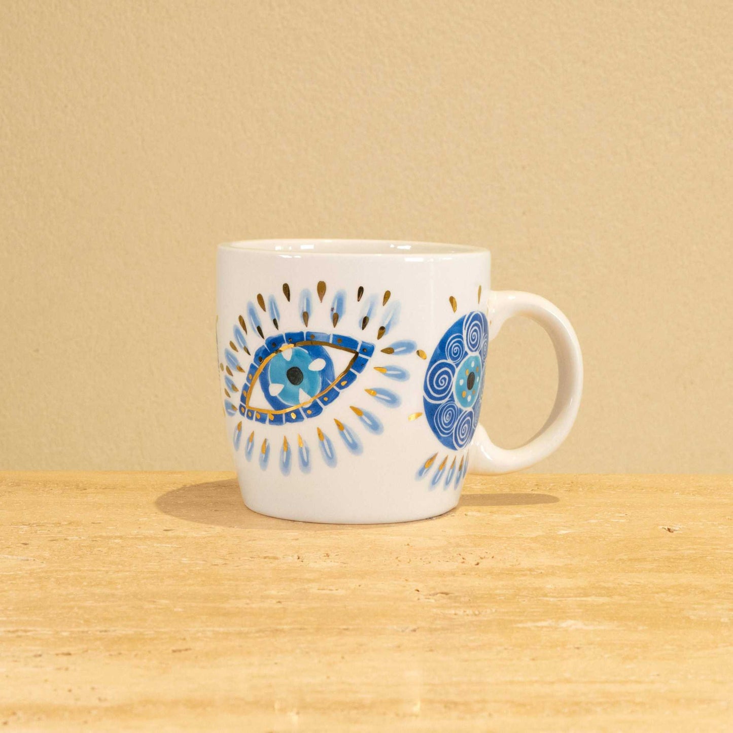 Handmade ceramic mug with gold-plated letter "M" and floral design.
