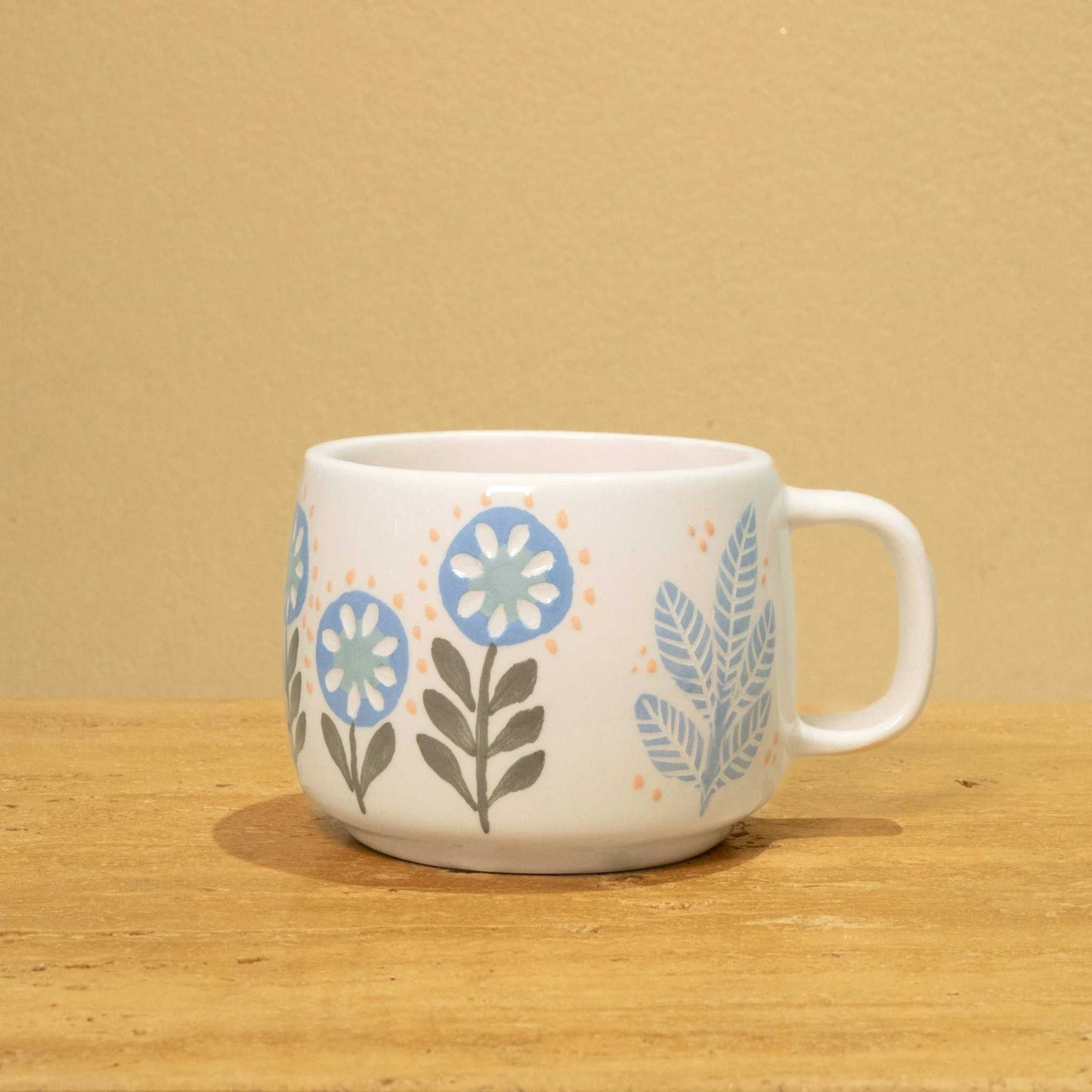 Personalized ceramic mug with gold Arabic monogram "Best Son in the World" and floral design.