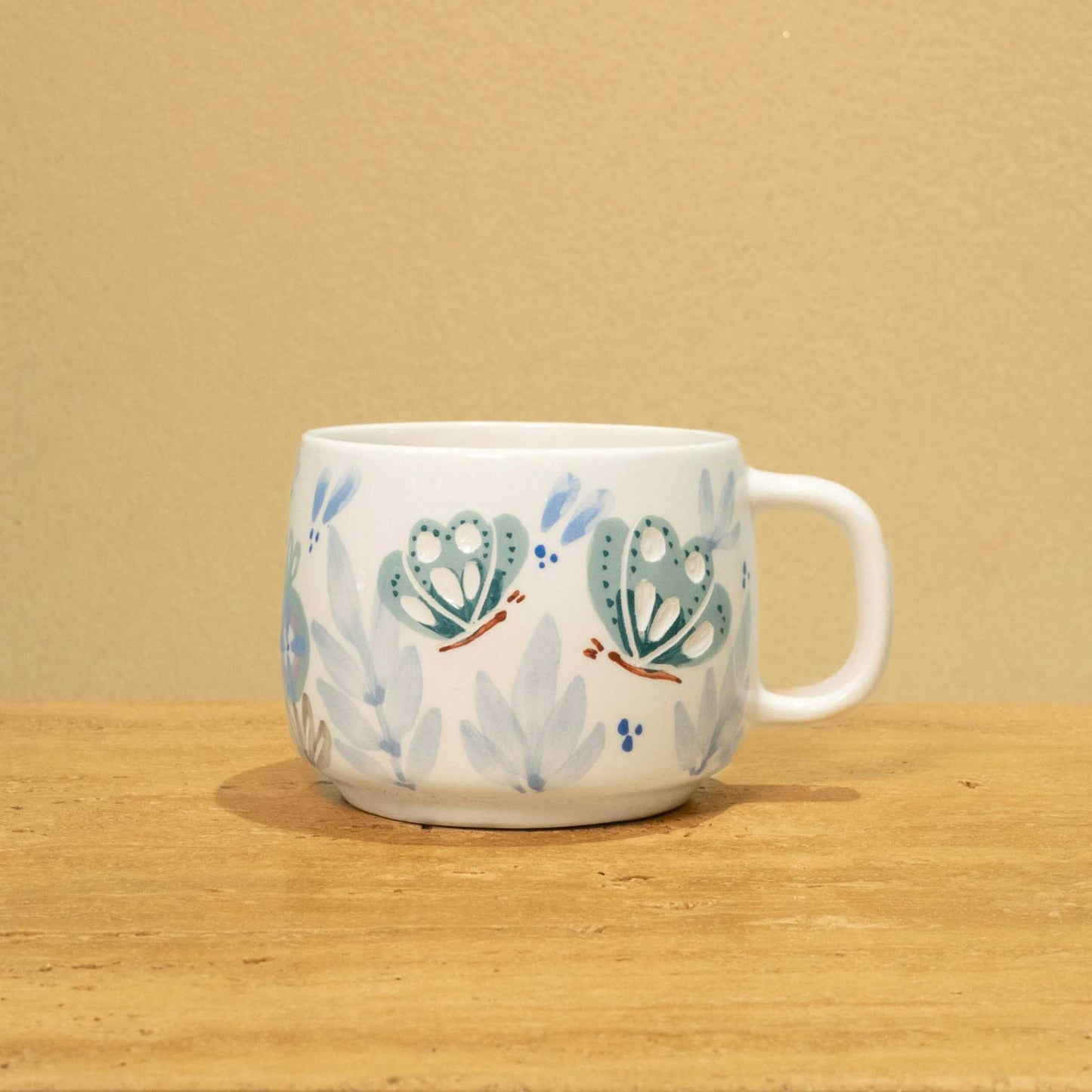 Personalized gold Arabic monogram ceramic mug with floral design, "Best Brother in the World".