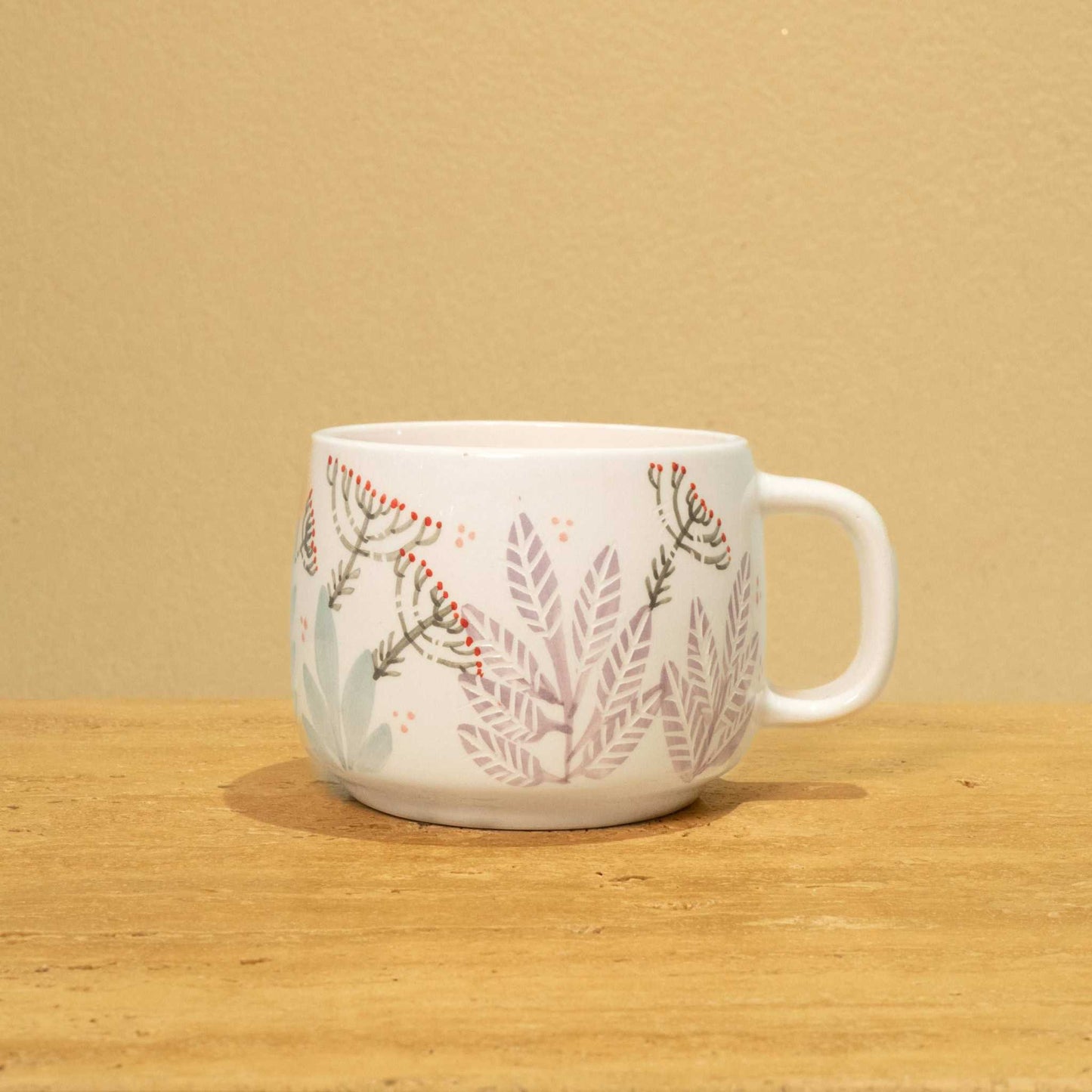 Best Mother In The World Ceramic mug with gold Arabic monogram and floral design.