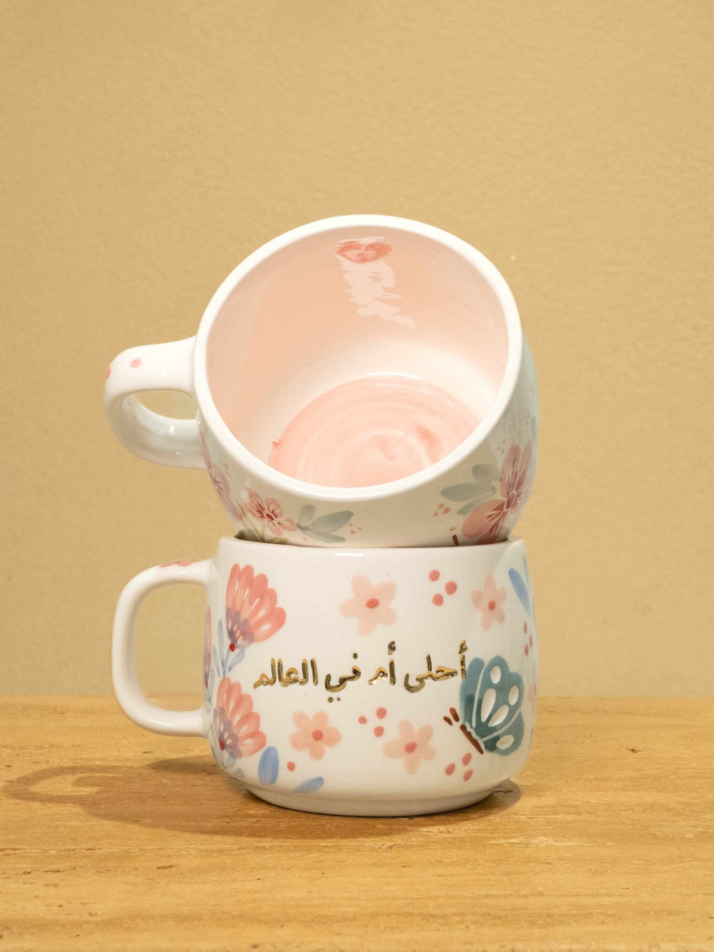 Best Mother In The World Ceramic mug with gold Arabic monogram and floral design.