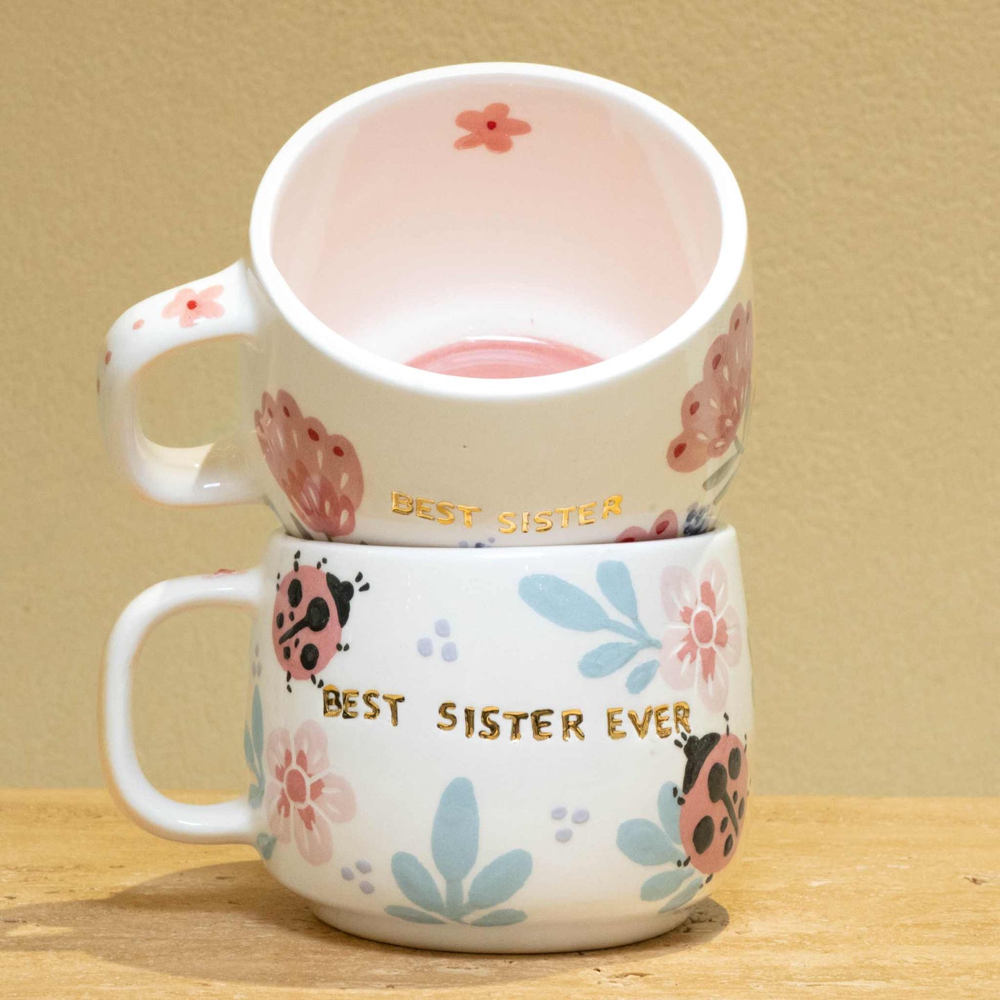 Handmade gold plated cup with "Best Sister" design, featuring unique floral patterns.