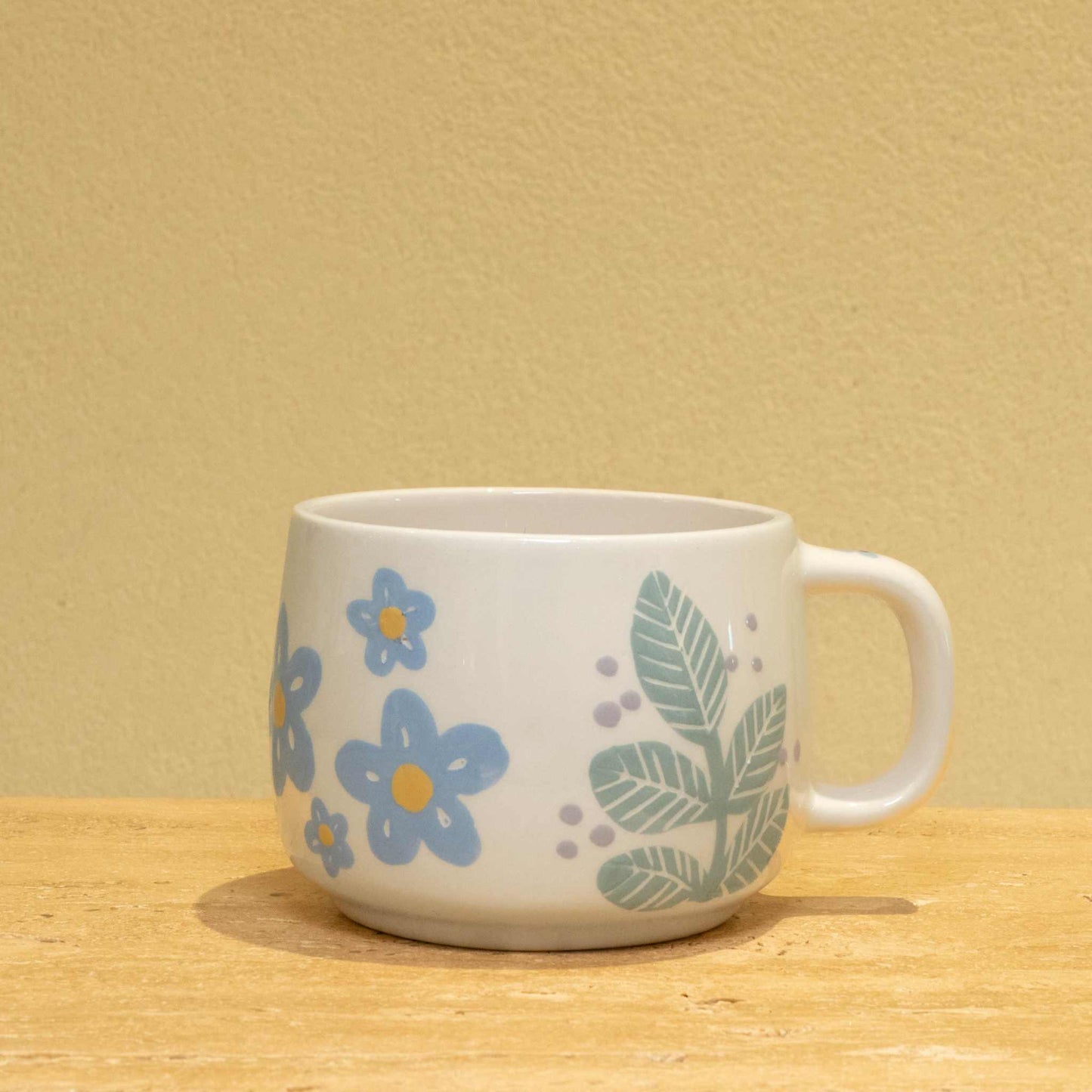 Personalized ceramic mug with gold "BEST MOTHER" and floral design.
