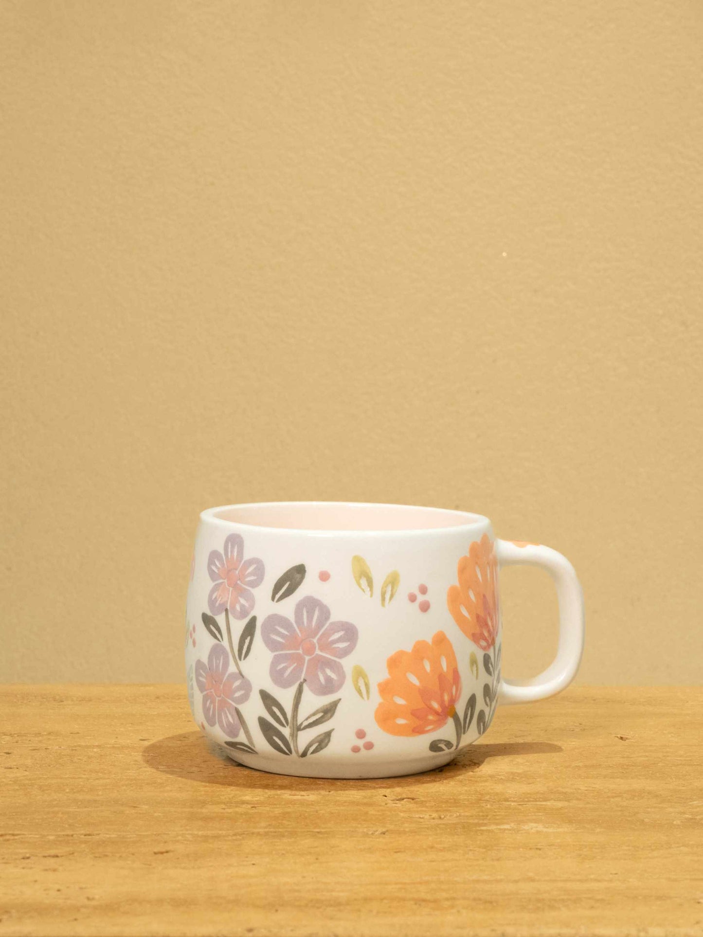 Handmade ceramic mug with gold Arabic monogram "Best Sister in the World" and unique floral design.