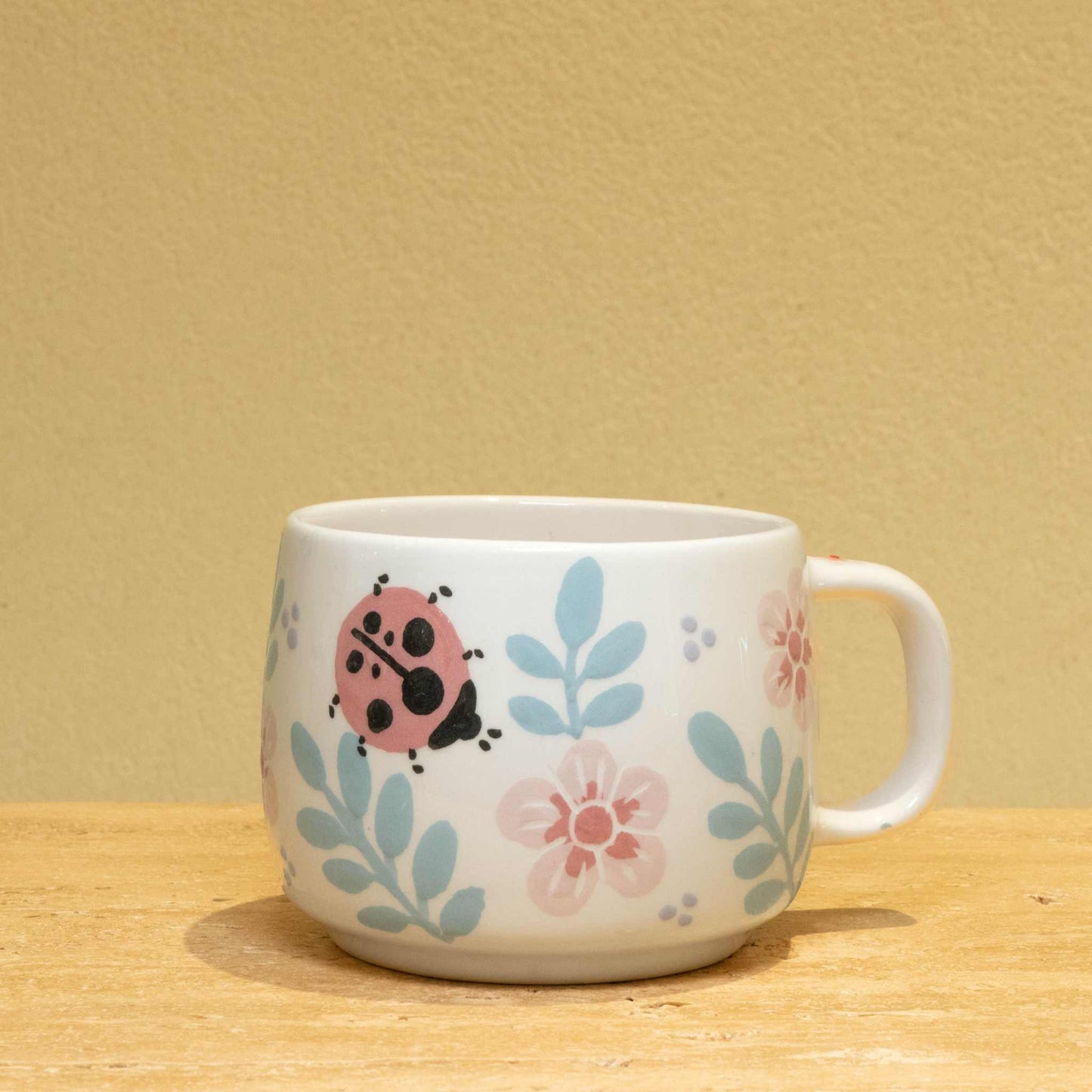 Handcrafted ceramic mug with gold "Best Wife Ever" monogram and floral design.