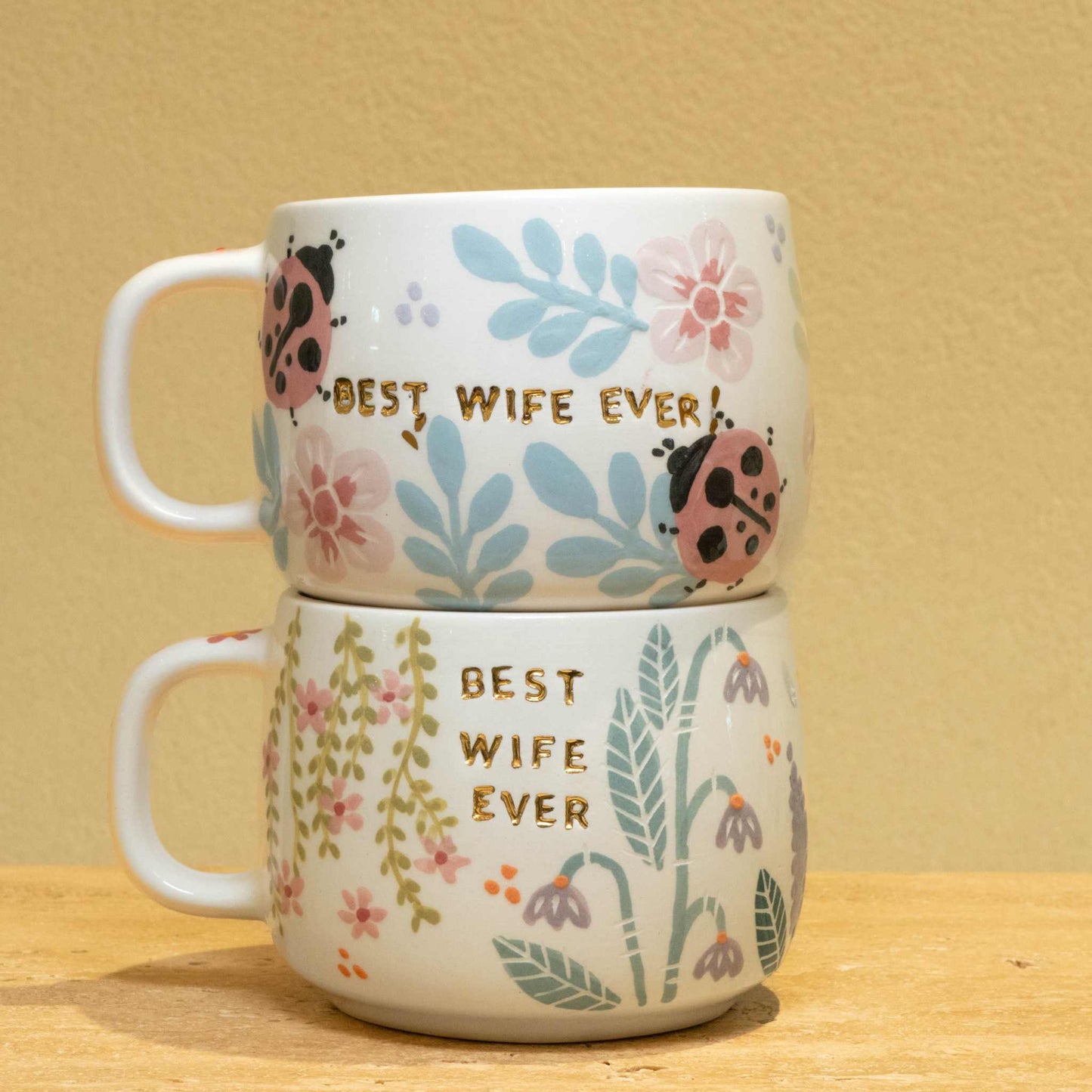 Handcrafted ceramic mug with gold "BEST WIFE EVER" and floral design.