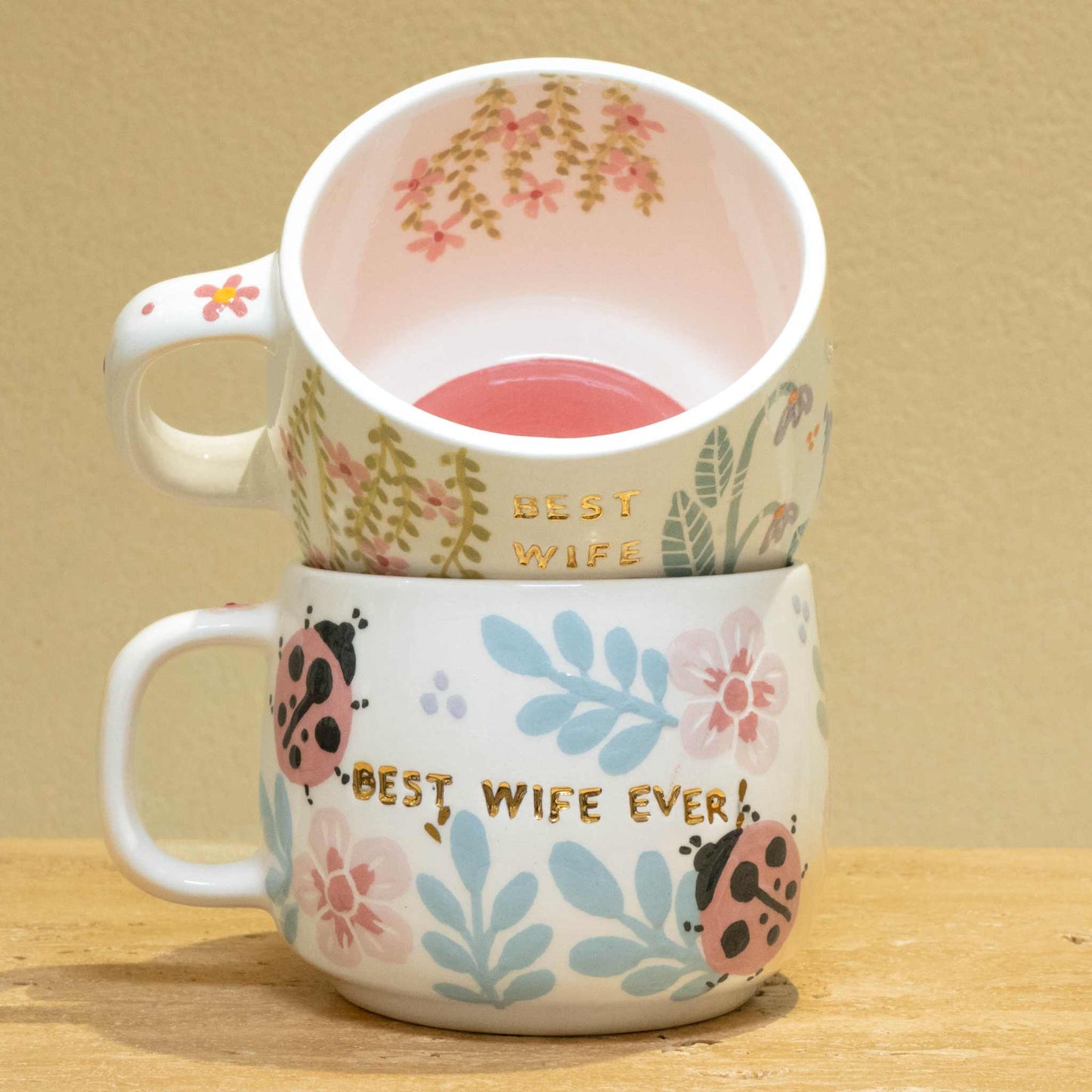 Personalized gold monogram ceramic mug with "Best Wife Ever" and floral design.