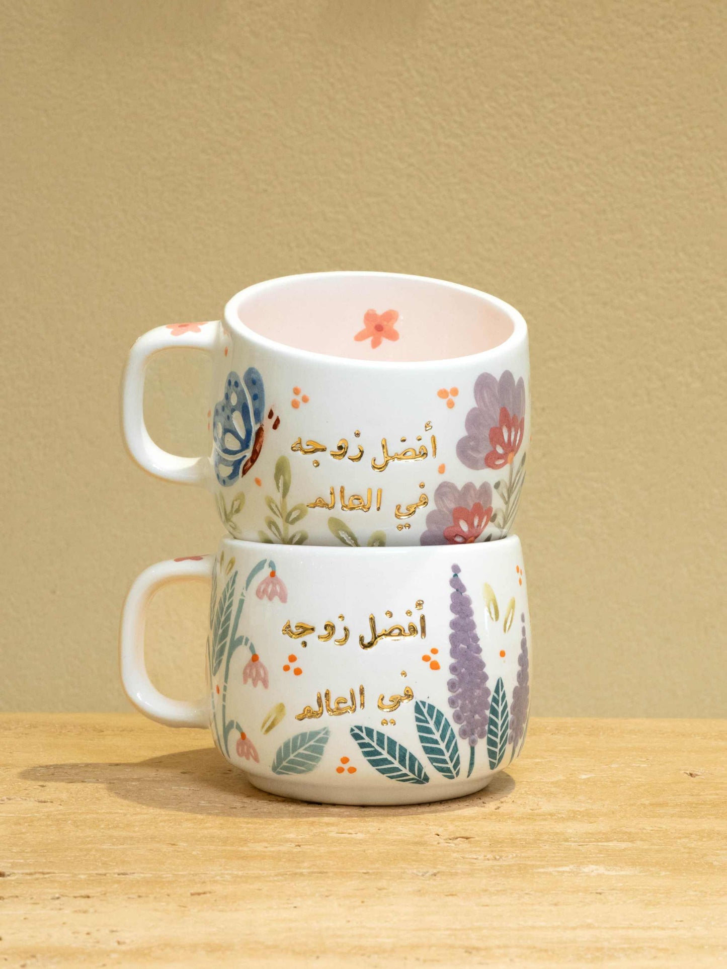 Personalized gold Arabic monogram ceramic mug with floral design.