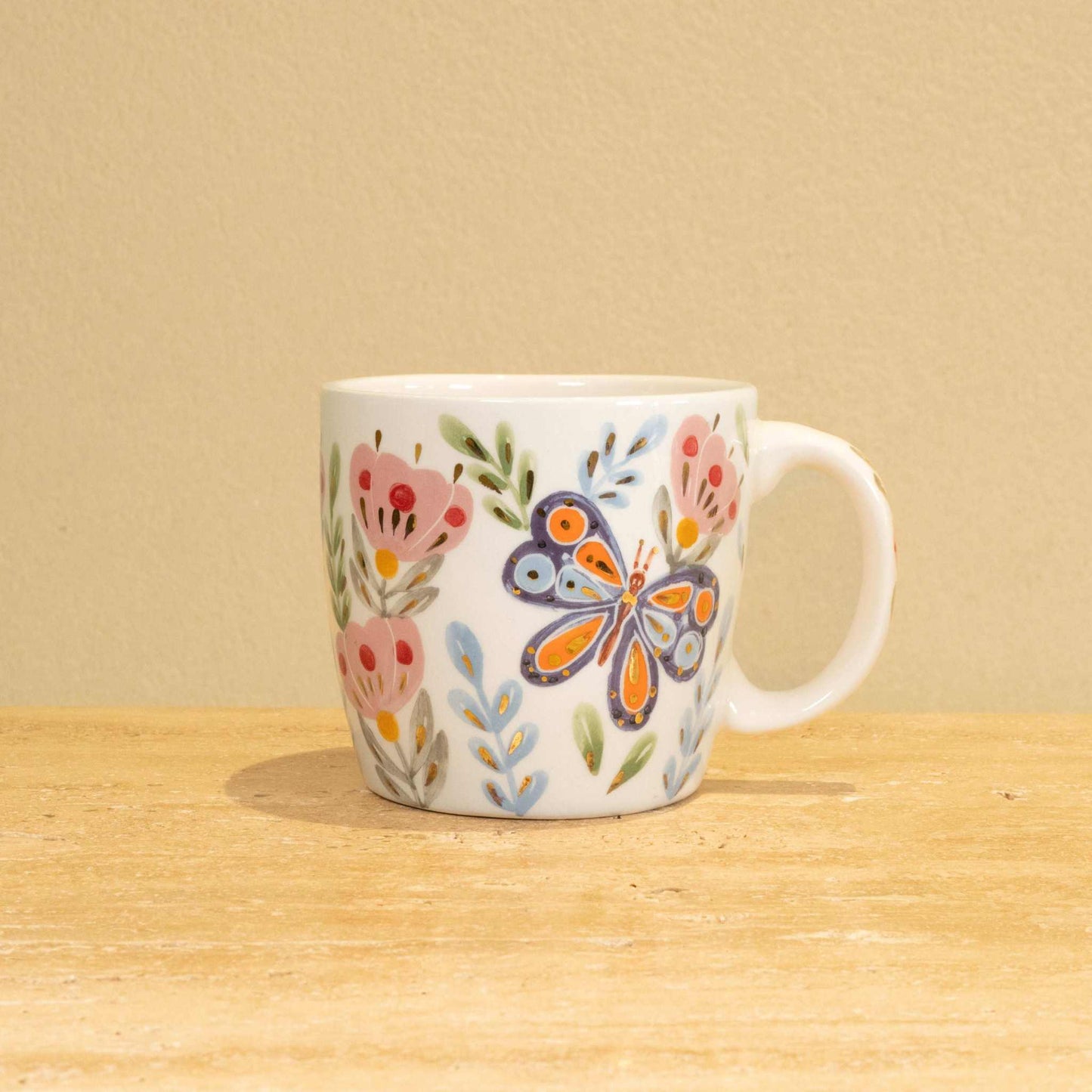 Custom handmade ceramic mug with gold-plated initial "G" and floral design.