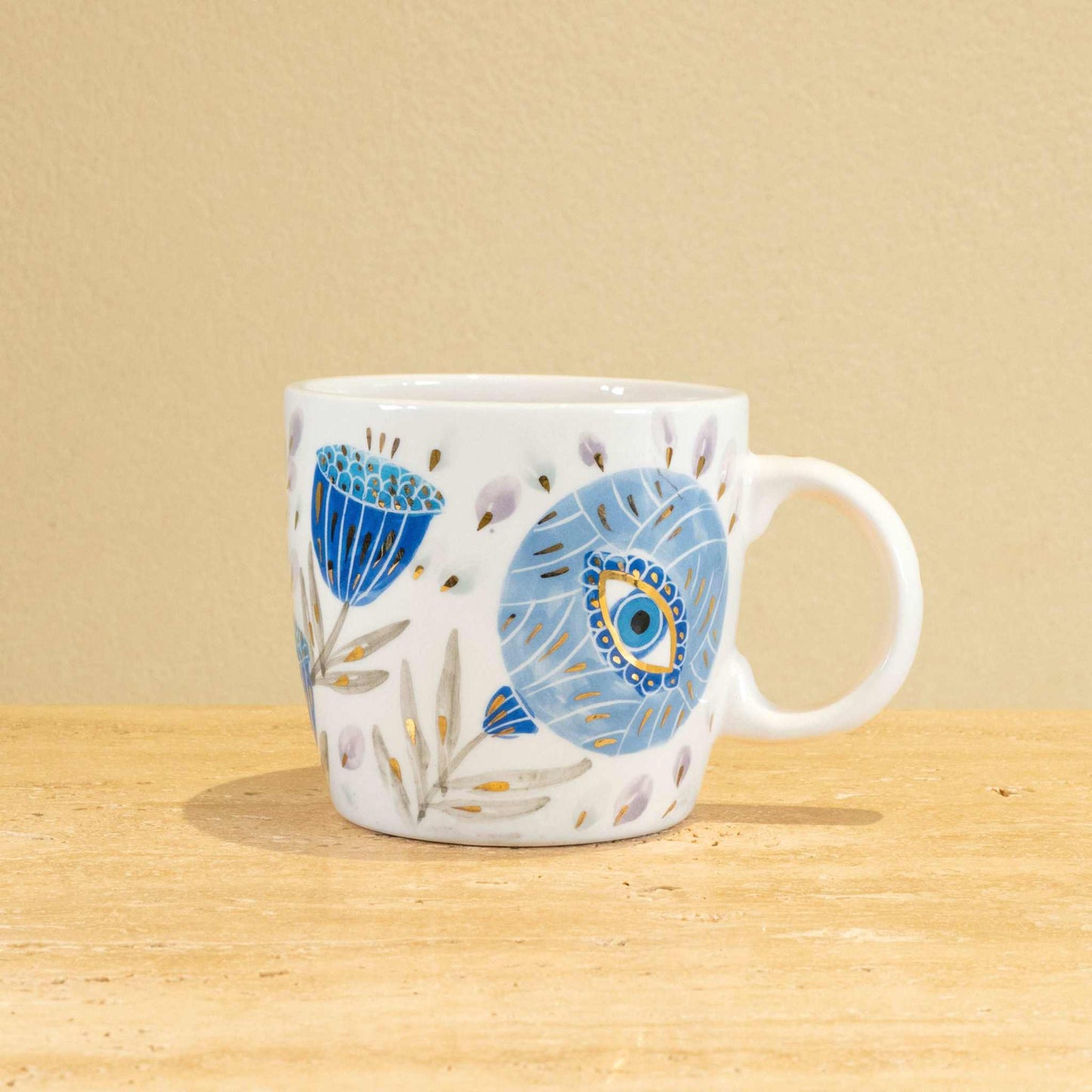Custom handmade ceramic mug with gold-plated initial "H" and floral design.