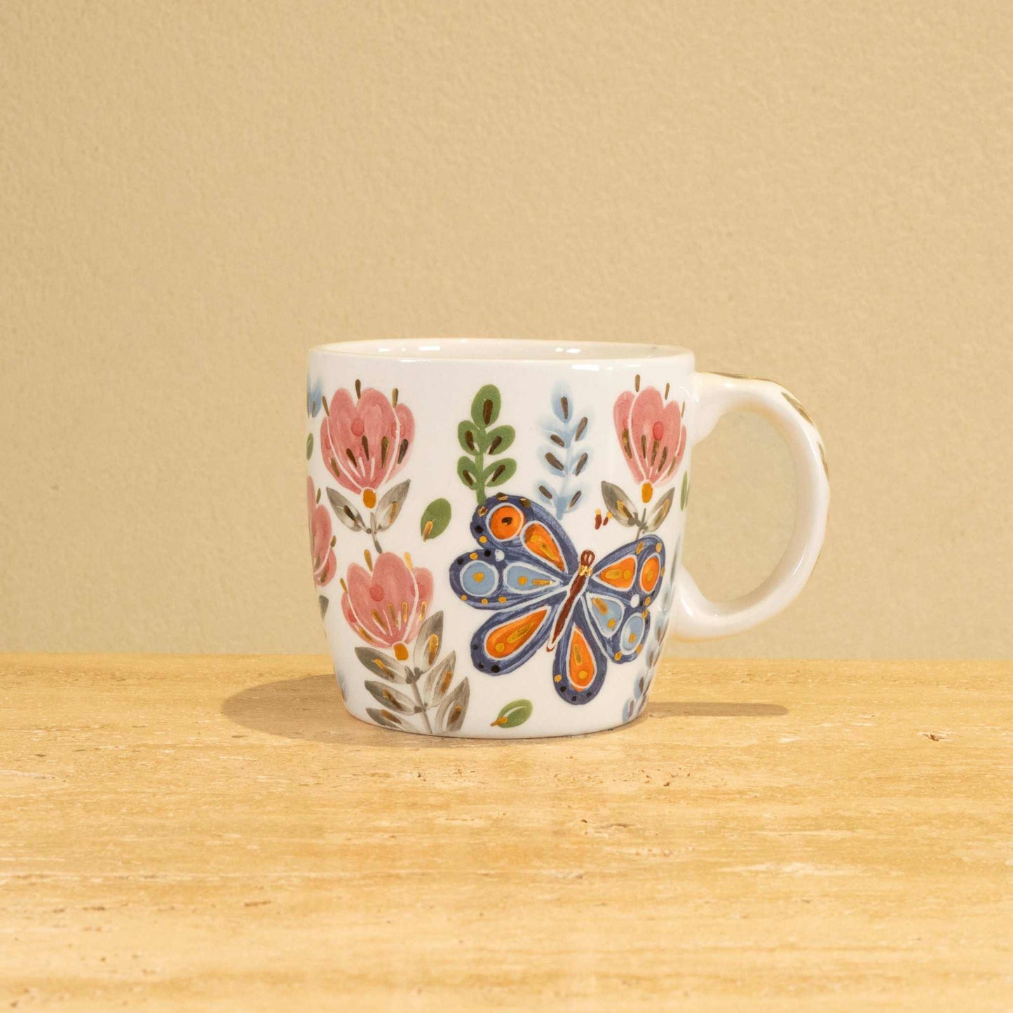 Custom handmade ceramic mug with gold-plated initial "P" and floral design.