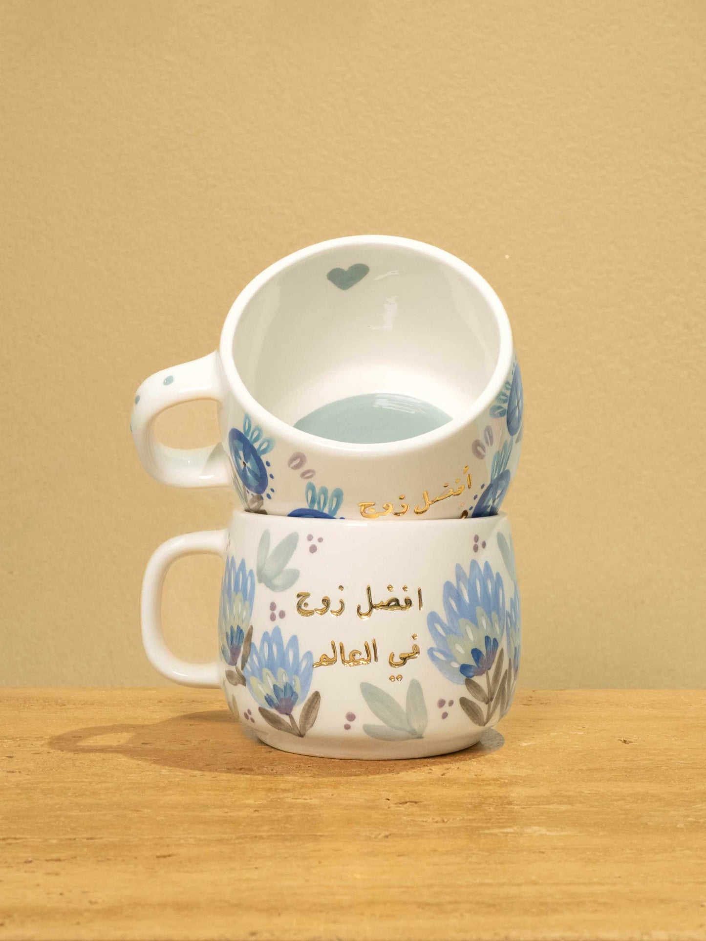 Personalized ceramic mug with gold Arabic monogram "Best Husband In The World" and floral design.
