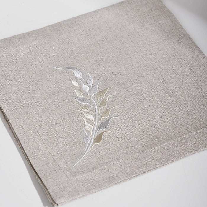 Natural linen cocktail napkin with FEATHERS GOLD-NATURAL embroidery in gold.