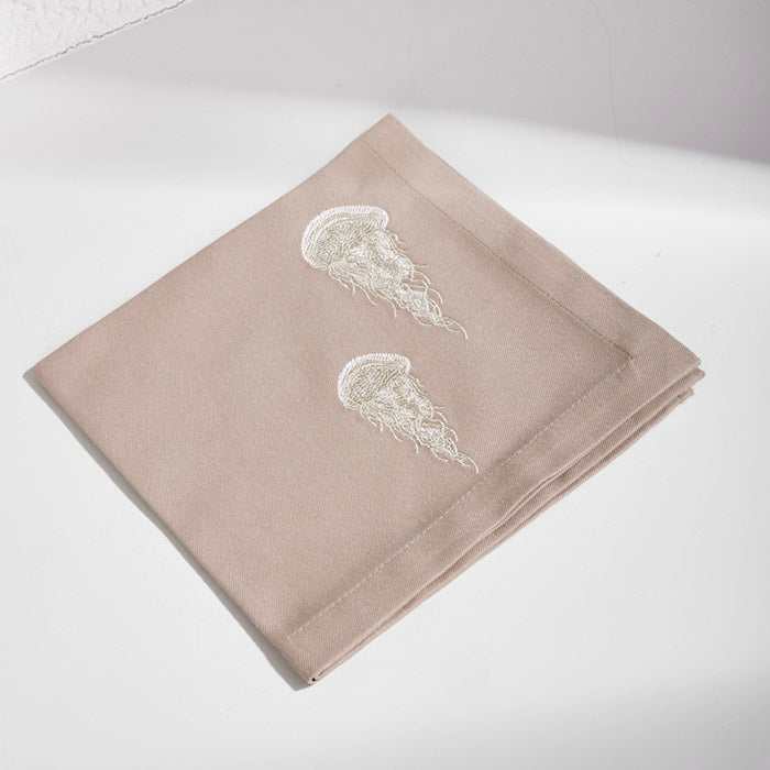 Jellyfish-Beta Beige placemat and napkin set with embroidered jellyfish design.