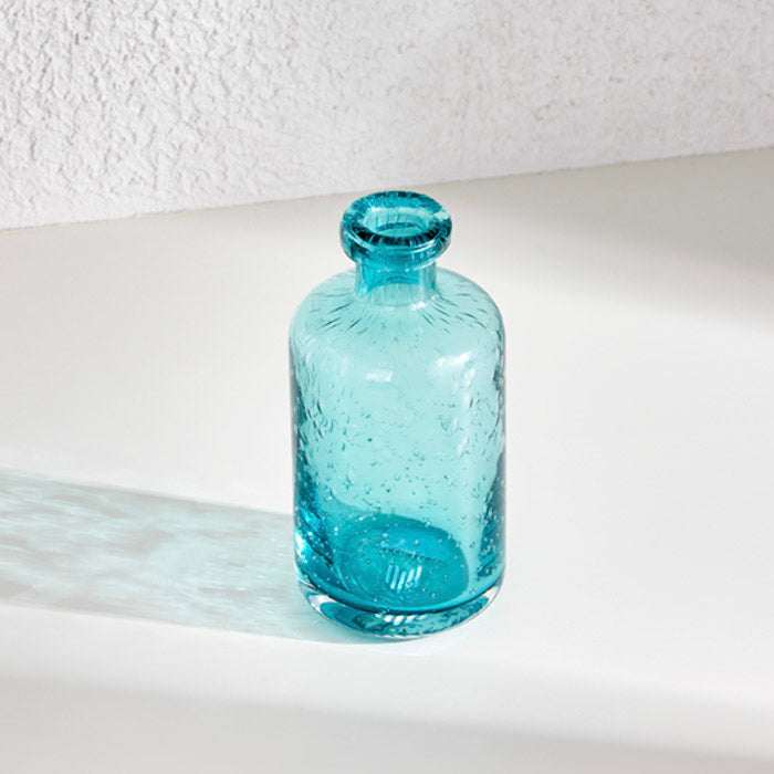 Apothecary glass vase in serene blue hue, perfect for floral display or standalone decor.