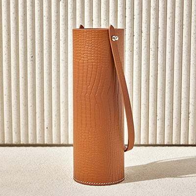 CYLINDER BOTTLE HOLDER LEATHER with crocodile-embossed texture and strap.