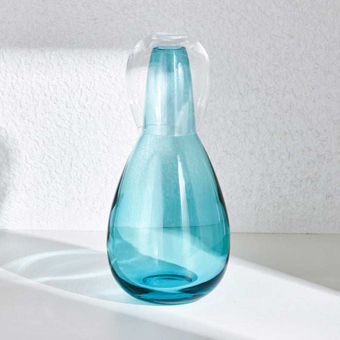 NUDE NIGHT WATER SET  1.5L - TURQUOISEElevate your bedside or tabletop with the NUDE Night Water Set in a captivating turquoise hue. Designed for both style and function, this sophisticated set includes Bottle
