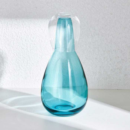 NUDE NIGHT WATER SET  1.5L - TURQUOISEElevate your bedside or tabletop with the NUDE Night Water Set in a captivating turquoise hue. Designed for both style and function, this sophisticated set includes Bottle