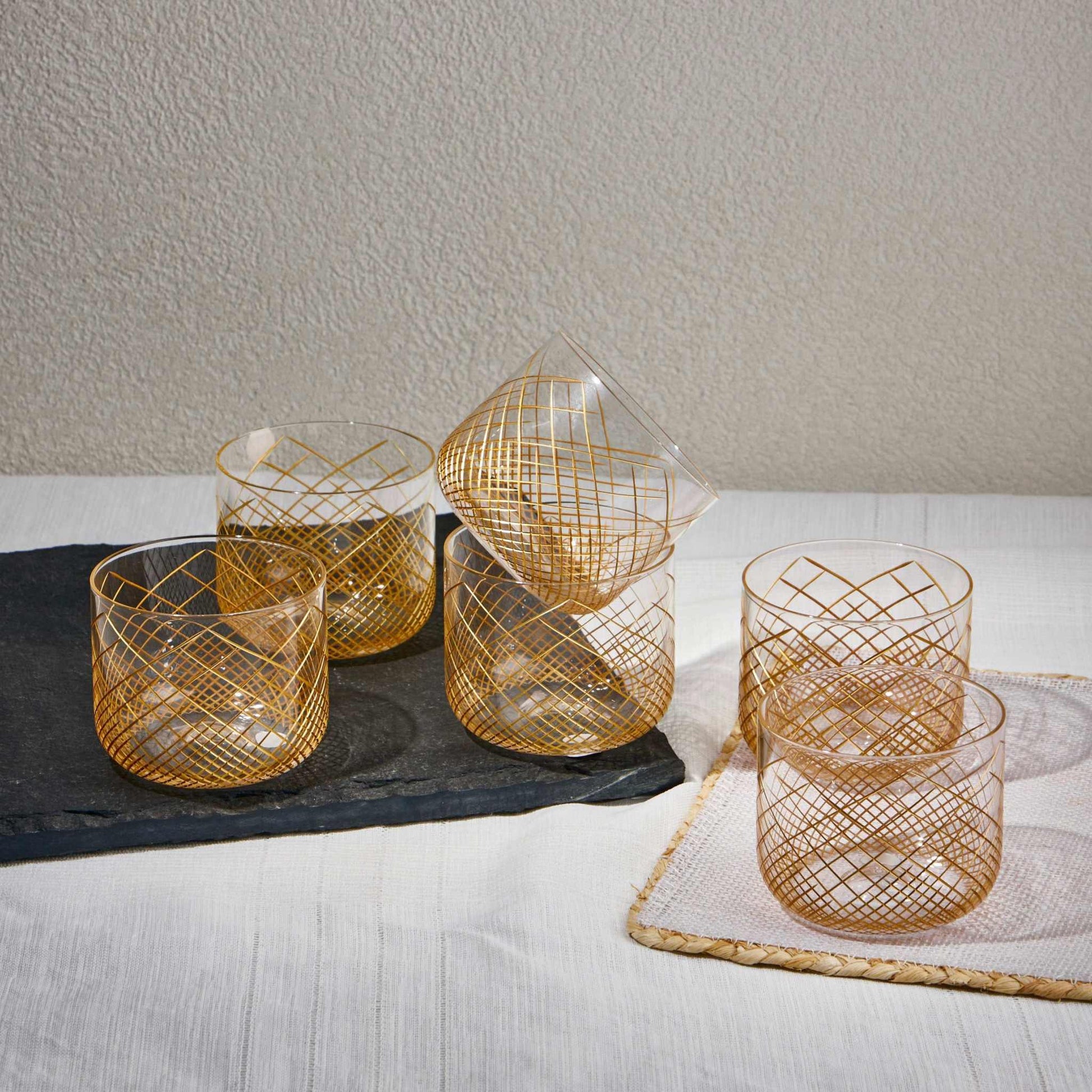 OMNIA GOLD GLASS SET OF 6Experience the charm of the OMNIA GOLD GLASS, a perfect blend of elegance and practicality. Crafted from premium-quality transparent glass with gold strips this cup Glass