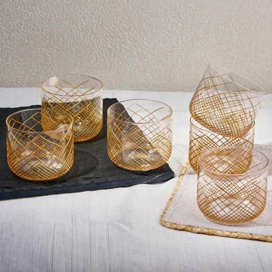 OMNIA GOLD GLASS SET OF 6Experience the charm of the OMNIA GOLD GLASS, a perfect blend of elegance and practicality. Crafted from premium-quality transparent glass with gold strips this cup Glass