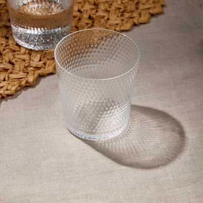 Whiskey Glass 380 ml with textured design on woven placemat, ideal for whiskey, bourbon, scotch, and cocktails.