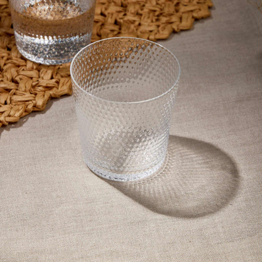 Whiskey Glass 380 ml with textured design on woven placemat, ideal for whiskey, bourbon, scotch, and cocktails.