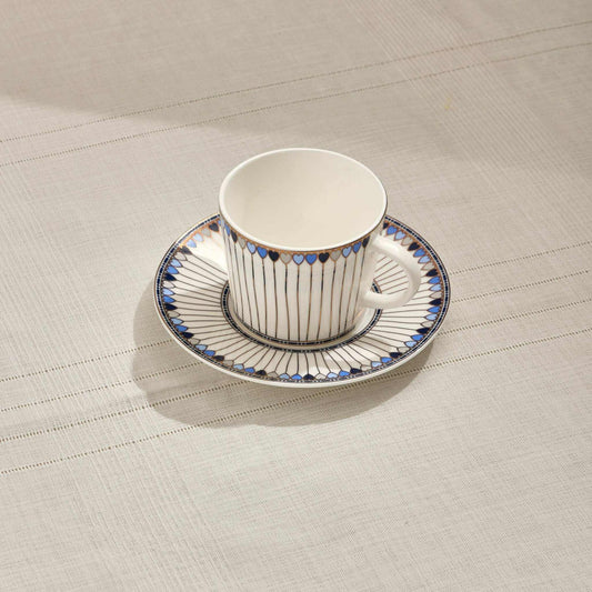 Hearts porcelain tea cup with blue heart-shaped accents on saucer.