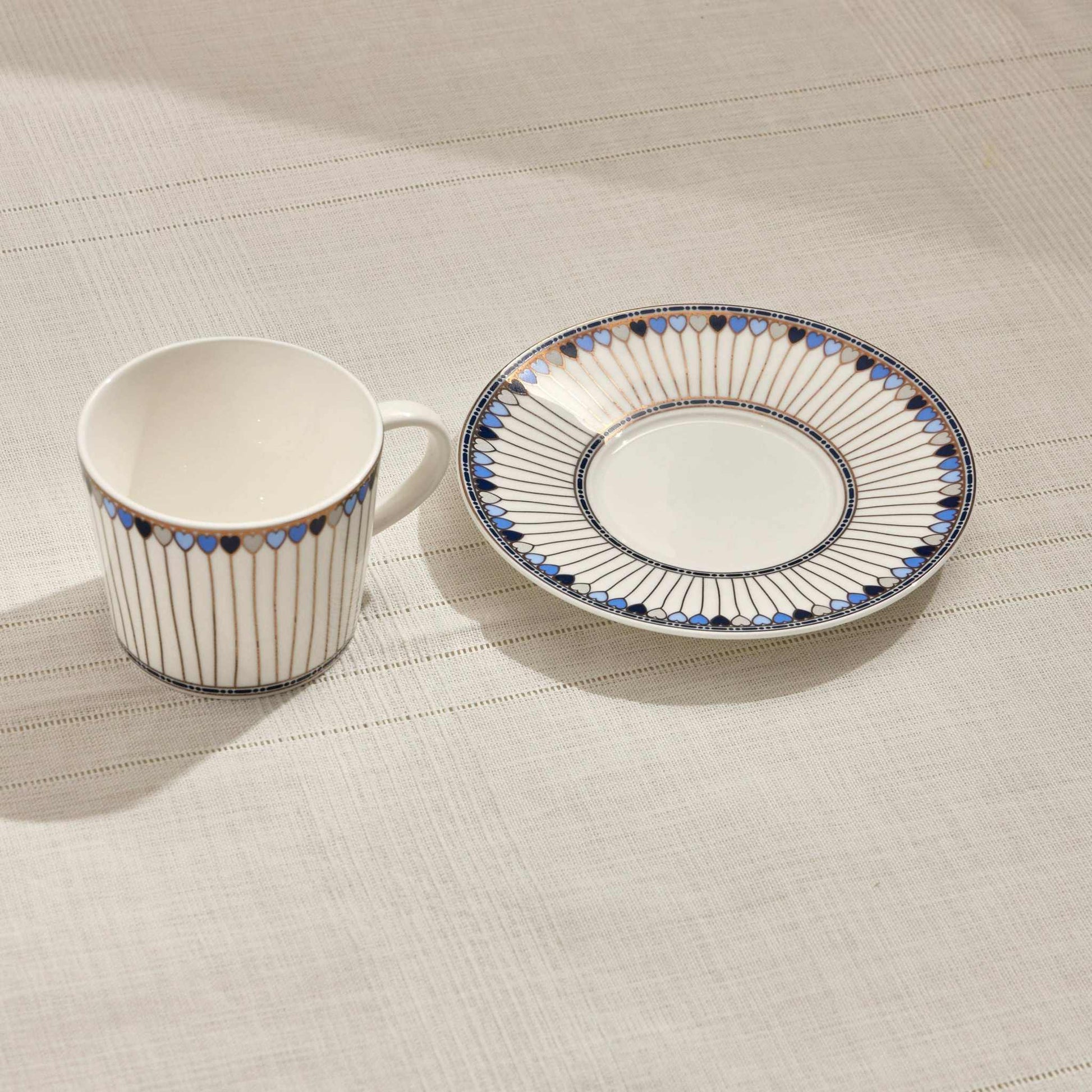 HEARTS PORCELAIN TEA CUP - BLUEAdd a touch of elegance to your tea time with this beautifully crafted porcelain tea cup and saucer set. Featuring a captivating red and white design with delicate hCUP AND SAUCER