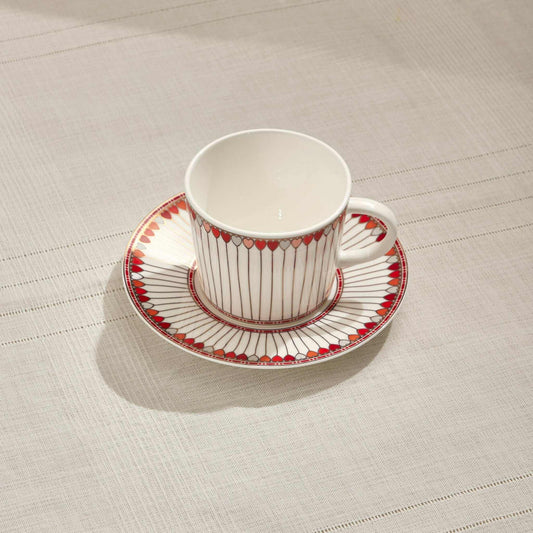 Hearts porcelain tea cup and saucer set in red and white with heart-shaped accents.