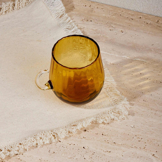 Optical Cup Amber with gradient glass, rippled texture, and amber tint on a textured surface.