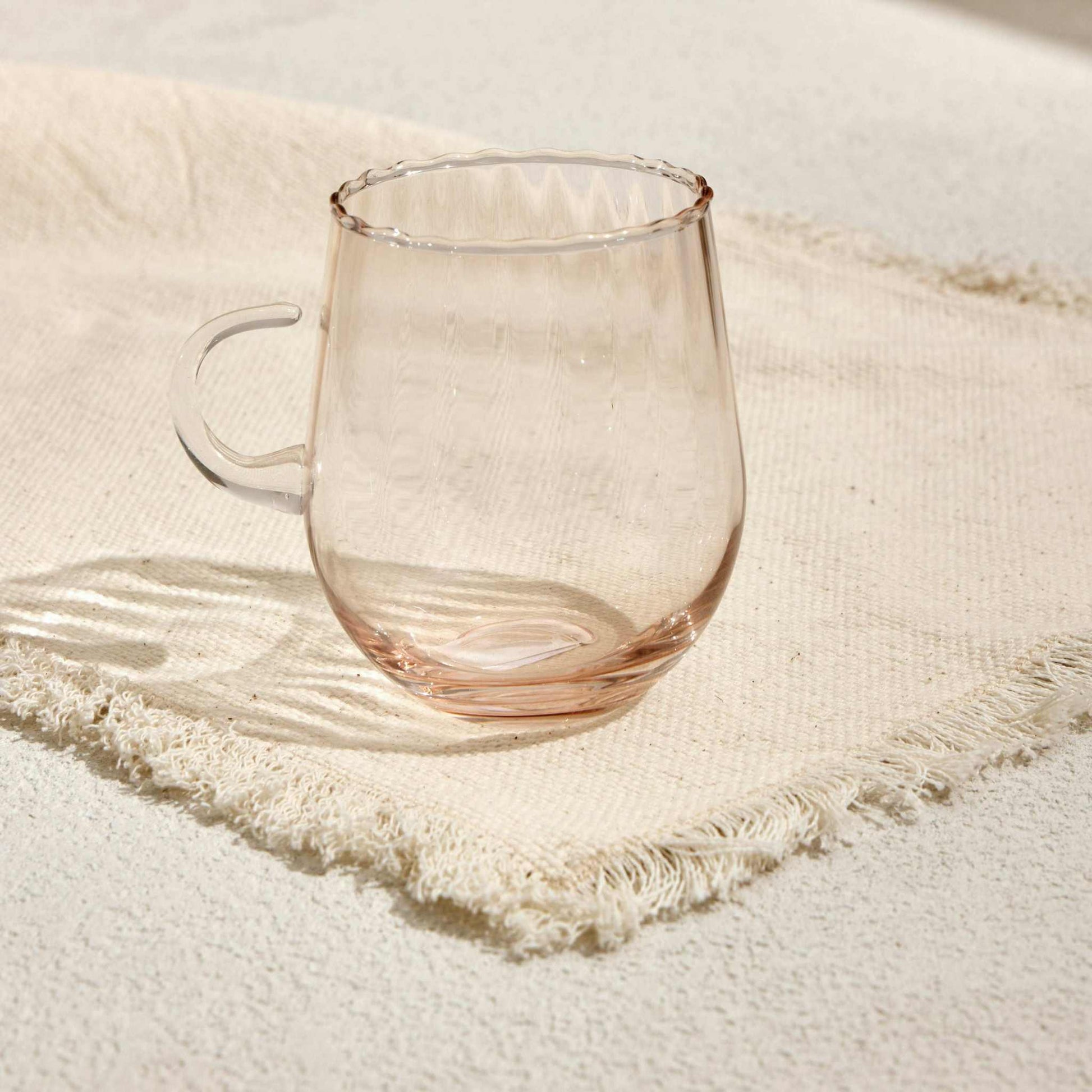 OPTIC CUP TARCINEIndulge in timeless elegance with the Optic Cup Tarcine, a beautifully crafted rippled glass mug designed for sophistication and style. With a delicate amber tint anGlass Mug