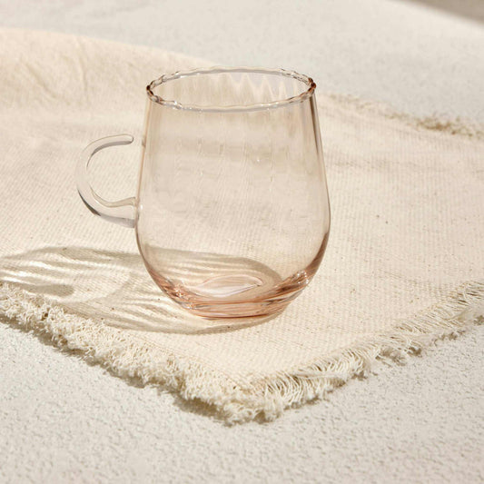 OPTIC CUP TARCINEIndulge in timeless elegance with the Optic Cup Tarcine, a beautifully crafted rippled glass mug designed for sophistication and style. With a delicate amber tint anGlass Mug