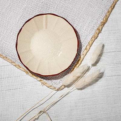 ACEM Ceramic Tea Plate in caramel hue with sunburst design and scalloped red edge.