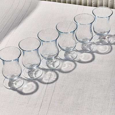 Socket the Glass elegant beverage set with sleek, curved design on table.