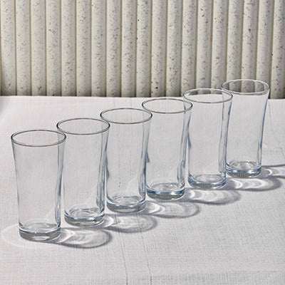 Six-piece glass set with elegant, curved design for versatile beverage serving.
