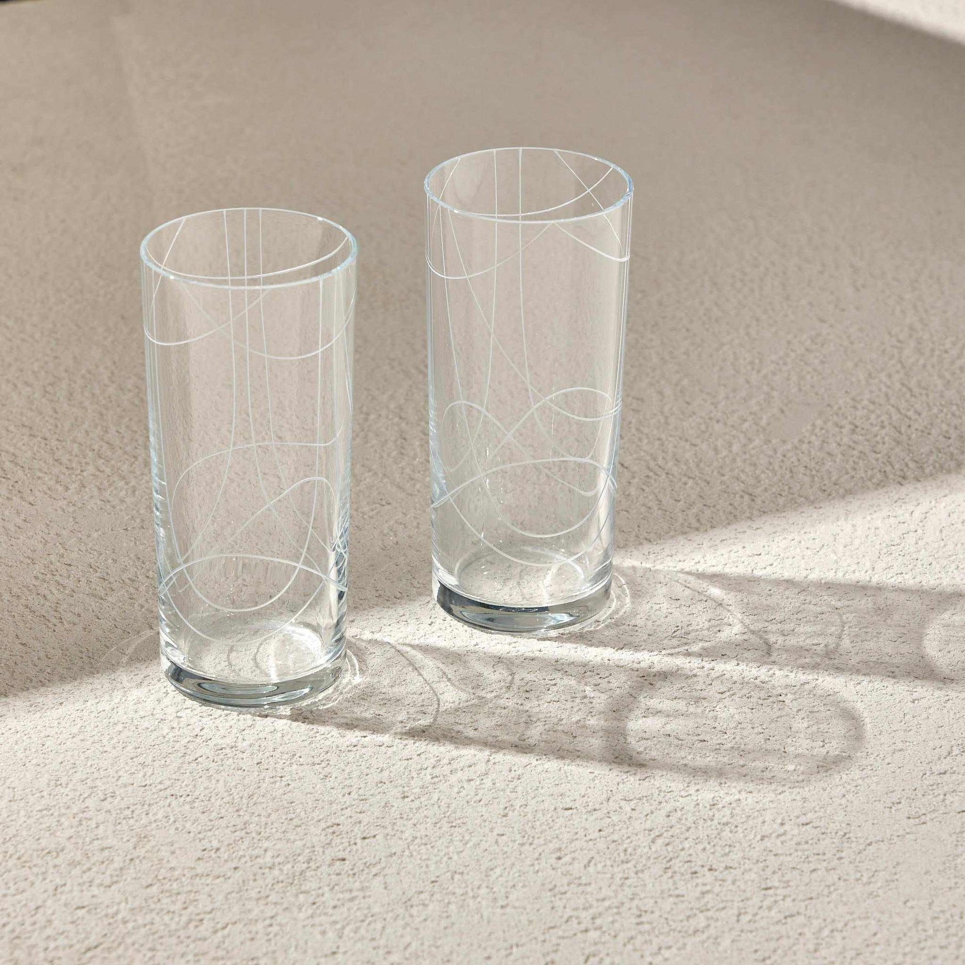 Elegant DOODLE RAKI Glass set with sleek, minimalist design on light surface.