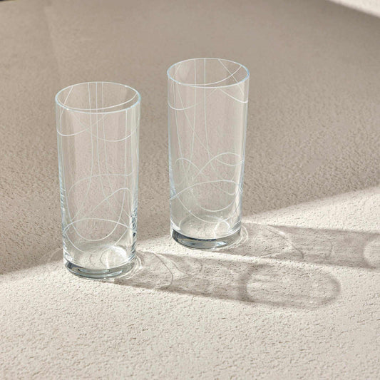 Elegant DOODLE RAKI Glass set with sleek, minimalist design on light surface.
