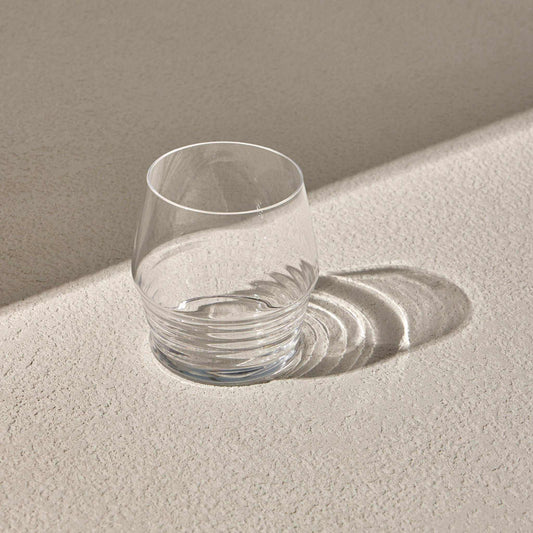 MOLIVO GLASS with detailed bottom design on textured surface.