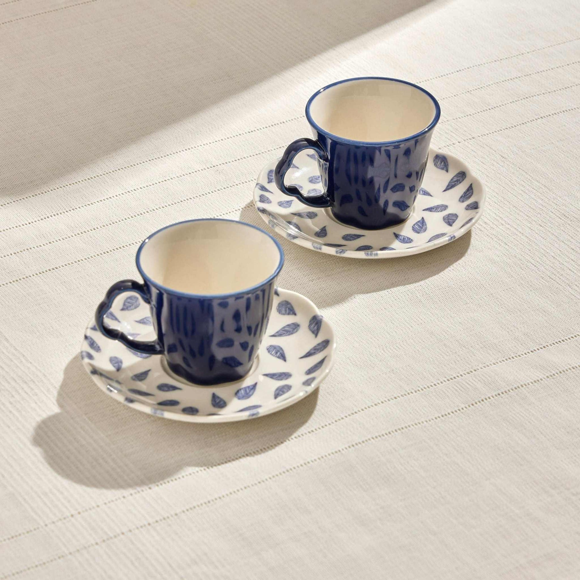 CLOVER LEAF PORCELAIN SET OF 2 COFFEE CUPS 80 ML - WHITE & BLUEThe Clover Leaf Porcelain Set of 2 Coffee Cups is a beautifully crafted duo designed for an elegant coffee experience. Each cup has an 80ml capacity, perfect for enjCUP AND SAUCER