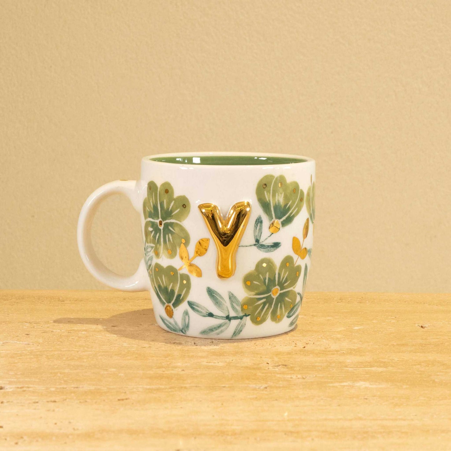 Personalized handmade ceramic mug with gold-plated letter "Y" and floral design.
