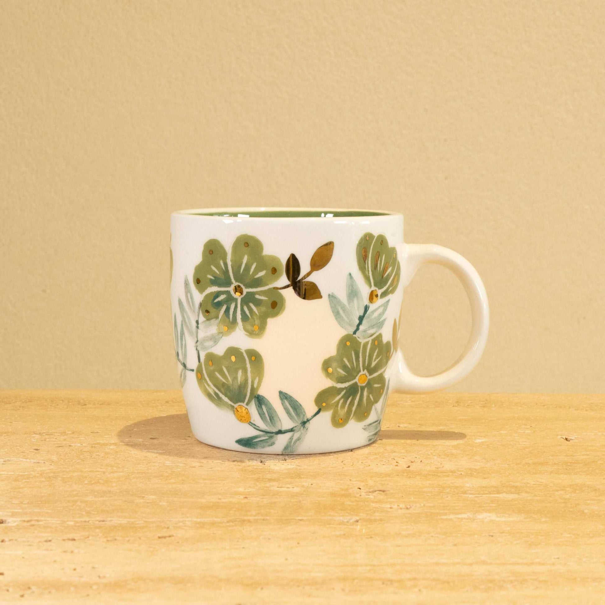 Personalized handmade ceramic mug with gold-plated letter "Y" and floral design.
