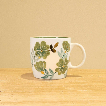 Personalized handmade ceramic mug with gold-plated letter "Y" and floral design.