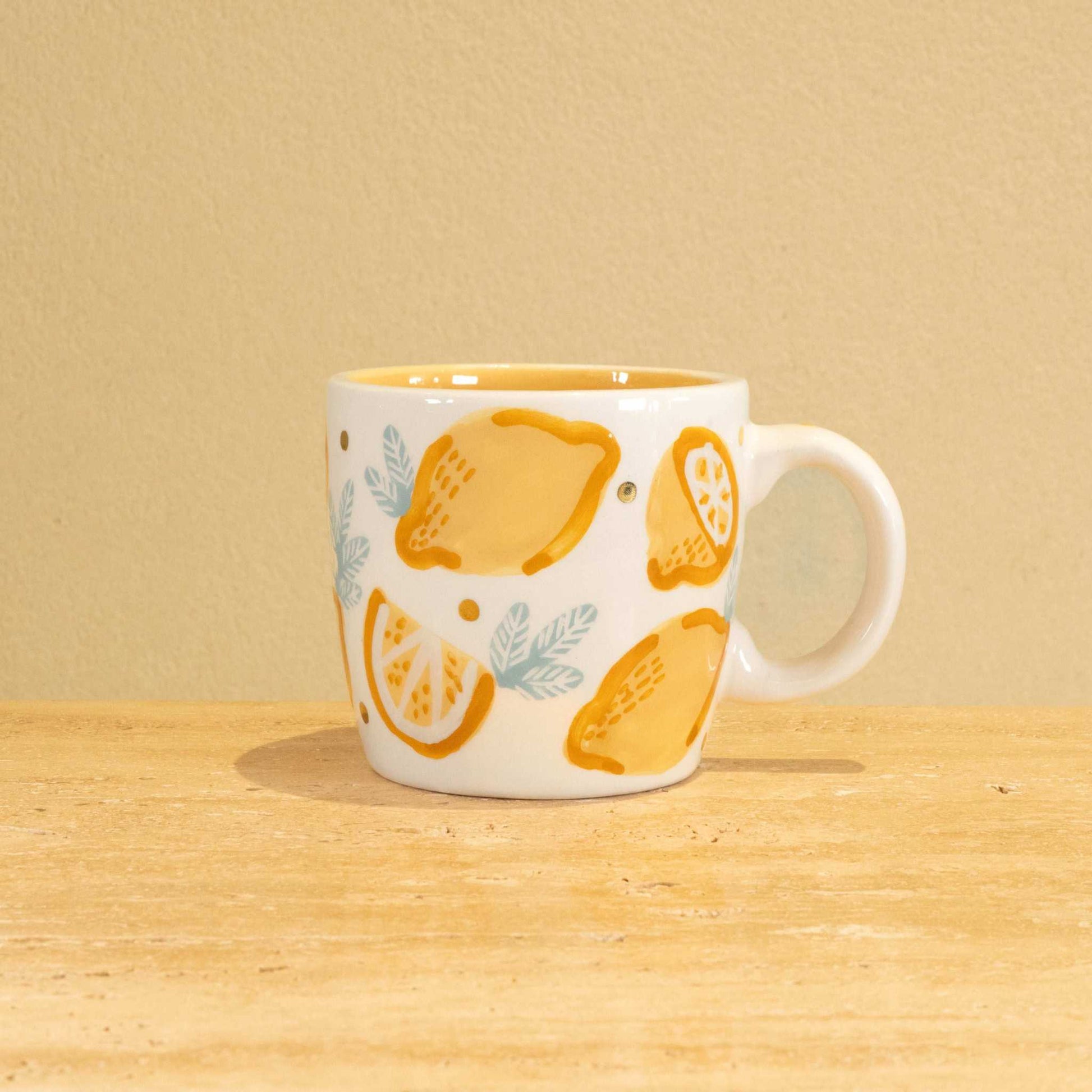 Personalized handmade ceramic mug with gold-plated letter M and floral design.